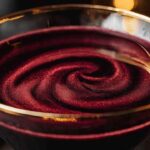 The Black Magic Martini is a dark and enchanting cocktail, perfect for Halloween or any mysterious occasion. Made with black vodka and raspberry liqueur, this sleek and sophisticated drink is as magical as it looks, especially when you add the red and gold luster dust for a shimmery effect.