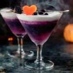 The Witch's Heart is a mesmerizing and spooky cocktail that's perfect for Halloween. With its deep, dark color and swirling shimmer, it looks as enchanting as it tastes. A blend of apple brandy, black vodka, and grenadine, this drink has a fruity yet haunting flavor that will be a hit at any Halloween party. Garnished with dry ice for a smoke-filled effect, it’s sure to captivate your guests.