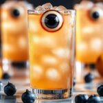 The Eyeball Highball is a spooky and fun Halloween drink, perfect for a festive party. It’s a twist on the classic highball, combining vodka and club soda with lychee “eyeballs” for a creepy yet refreshing look. These eyeball garnishes, made from lychee and blueberries, float eerily in the drink, giving it a frightful appearance that's sure to impress your guests.