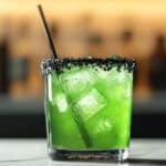 This creepy, green-hued Beetlejuice Cocktail is the perfect mix of sweet and sour, making it a fun and spooky addition to any Halloween party. With a refreshing blend of citrus and tropical flavors, it's a crowd-pleaser that's easy to mix up and enjoy.