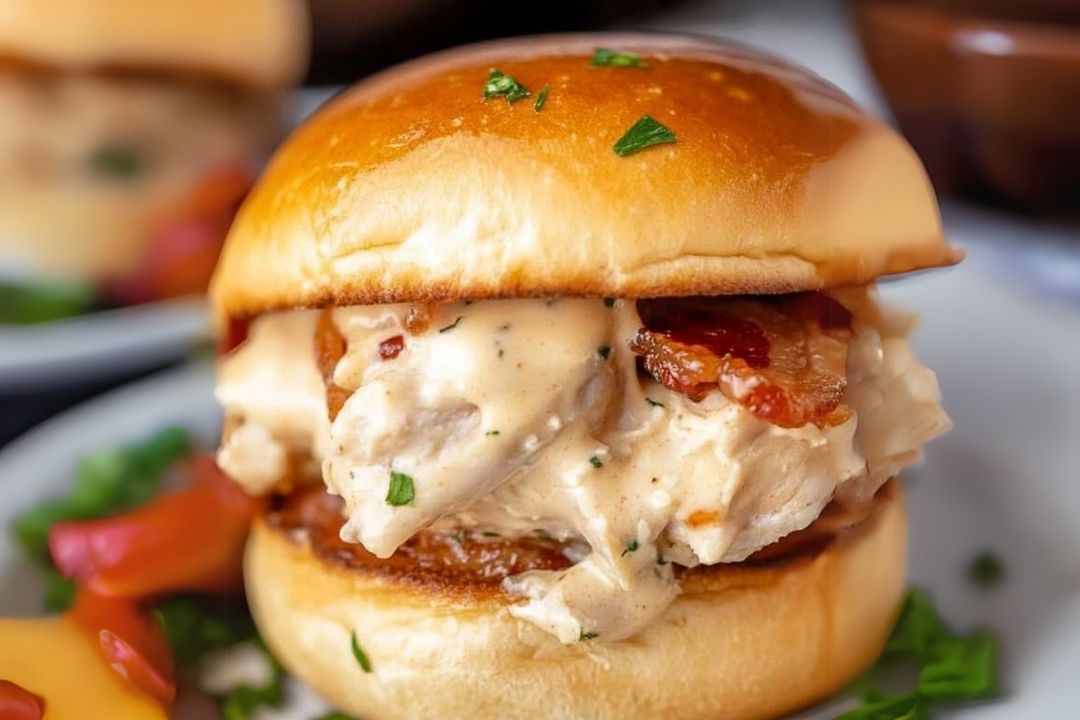 These baked chicken bacon ranch sliders are made with soft slider buns, shredded chicken tossed in a savory ranch sauce with sharp cheese and crispy bacon, then topped with a garlic butter sauce!