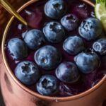 The classic Moscow Mule gets a refreshing twist with the addition of sweet blueberries and a hint of mint. Served in the signature copper mug, this cocktail blends tangy lime, spicy ginger beer, and juicy blueberries for a drink that's as vibrant as it is delicious. It’s perfect for sipping on a warm evening, impressing friends at a gathering, or adding a fruity spin to your cocktail hour.