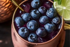 The classic Moscow Mule gets a refreshing twist with the addition of sweet blueberries and a hint of mint. Served in the signature copper mug, this cocktail blends tangy lime, spicy ginger beer, and juicy blueberries for a drink that's as vibrant as it is delicious. It’s perfect for sipping on a warm evening, impressing friends at a gathering, or adding a fruity spin to your cocktail hour.