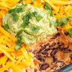 7 Layer Dip: Packed with Refried Beans, Tangy Guacamole, Spiced Sour Cream, Zesty Salsa, and Topped with Cheese