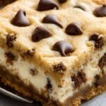 If you love chocolate chip cookies and creamy cheesecake, this recipe is about to become your new favorite. Chocolate Chip Cookie Cheesecake Bars combine the best of both worlds—soft, chewy cookie layers sandwiching a rich and velvety cheesecake filling. They’re easy to make and impossible to resist!