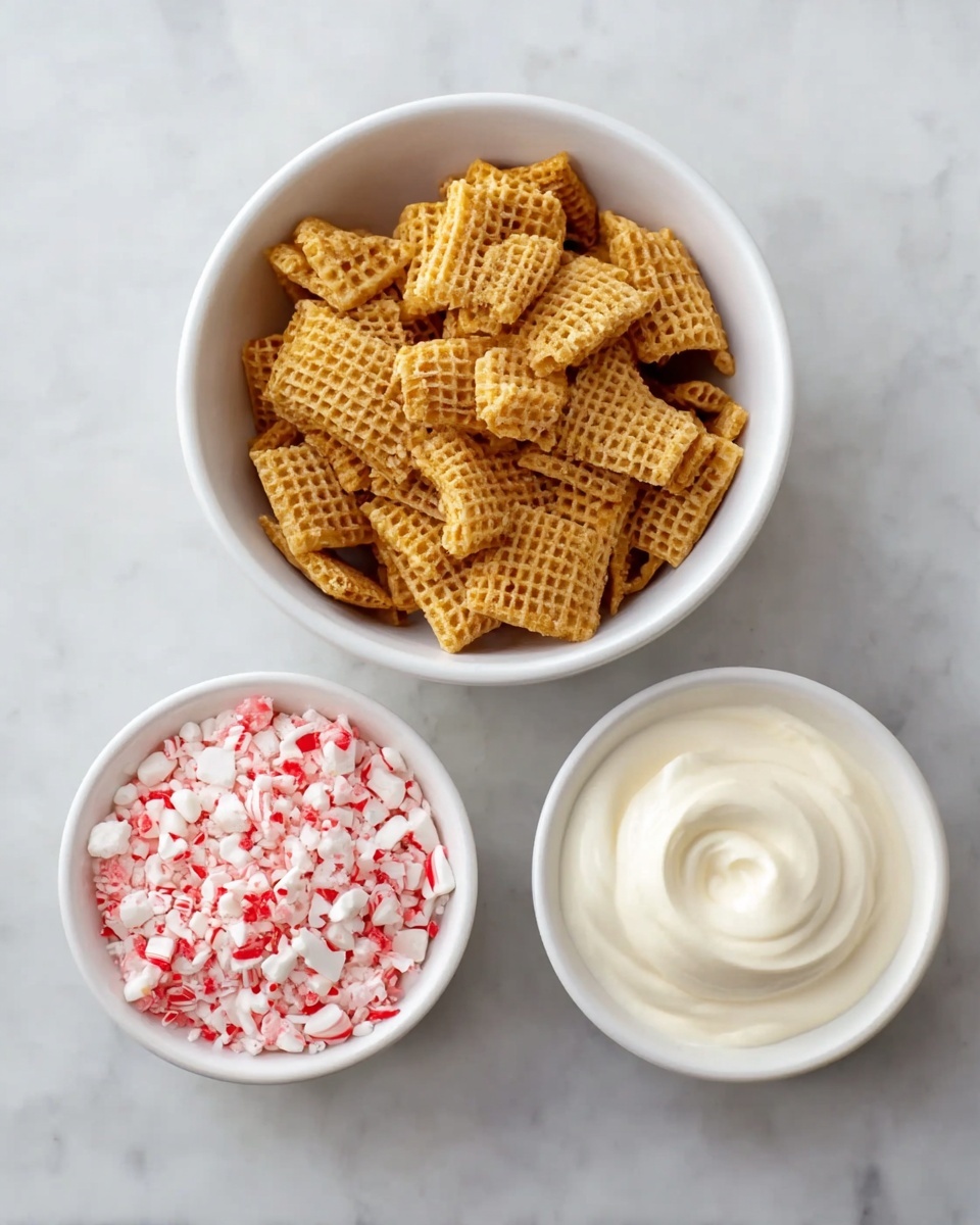 Peppermint Bark Puppy Chow Recipe 4 The image shows three white bowls placed on a white marbled surface. The largest bowl, positioned at the top, is filled with a thick layer of light brown square cereal pieces with a textured, grid-like surface. Below this bowl to the right is a medium white bowl with a smooth, swirled layer of creamy white yogurt. To the left of the yogurt bowl, there is a small white bowl filled with roughly broken pieces of red and white peppermint candy, creating a colorful contrast with the other ingredients. Photo taken with an iphone --ar 4:5 --v 7