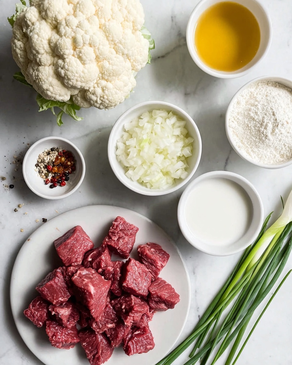 Beef Tips with Cauliflower Mash and Thickened Gravy Recipe 2 The image shows a collection of cooking ingredients arranged on a white marbled surface. In the foreground, there is a white plate filled with thick, red beef chunks. To the left, a whole white cauliflower rests directly on the surface. Around the main plate are several white bowls: one with diced white onions, one with a golden yellow liquid (likely oil), one with a white powder (probably flour), and another with a similar white powder but slightly different texture. A small white dish contains mixed spices, including light brown, black peppercorns, and pale seeds. On the right side of the image, there is a small bunch of fresh green chives or scallions placed on the surface. photo taken with an iphone --ar 4:5 --v 7